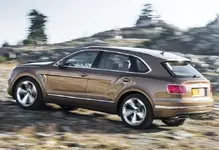 Bentley-Bentayga-Rear-Driving.webp