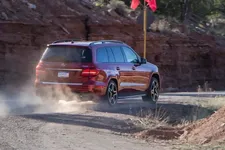 2017-mercedes-benz-gls550-red-rear-driving-away.webp